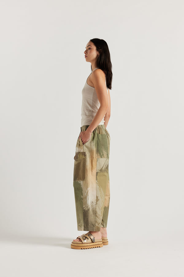 Side of Model wearing the Wing tank in bone jersey. A slim-fit cotton jersey tank with a slight racer neckline. A clean, minimal silhouette