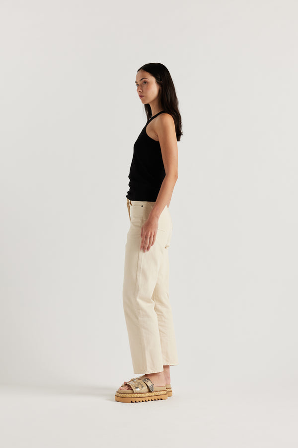 Side of Model wearing the Wing tank in black jersey. A slim-fit cotton jersey tank with a slight racer neckline. A clean, minimal silhouette