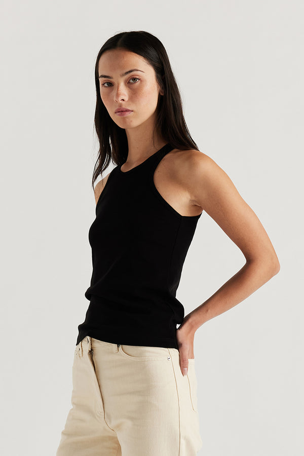 Front of Model wearing the Wing tank in black jersey. A slim-fit cotton jersey tank with a slight racer neckline. A clean, minimal silhouette