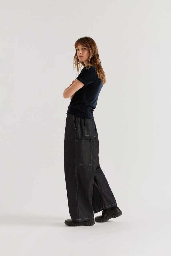 Back view of relaxed cargo pants in indigo featuring patch pockets and premium Japanese denim construction.