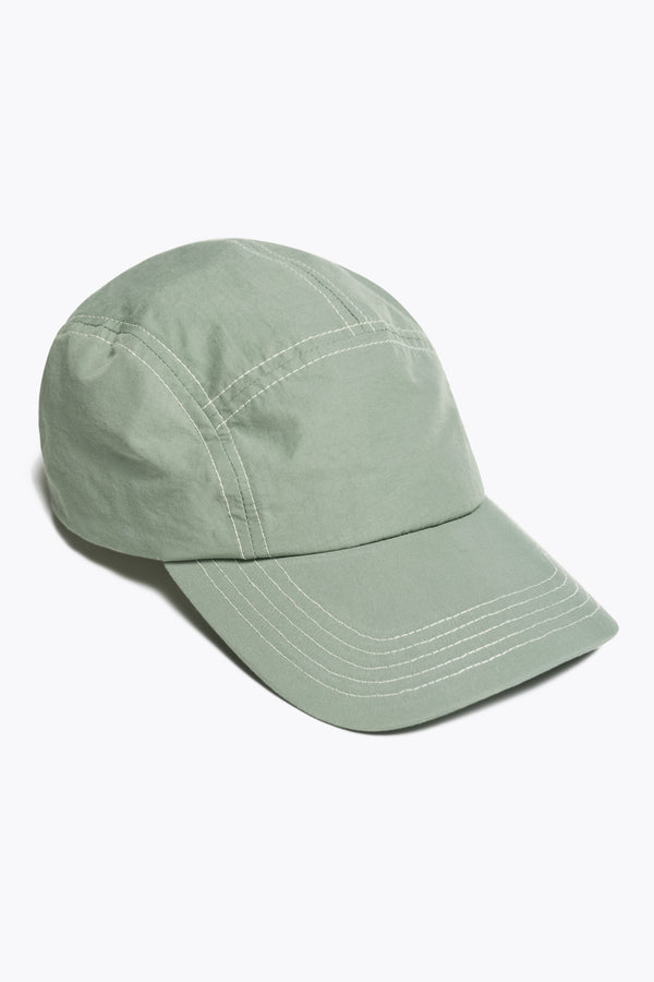 Front of the Unisex olive green 5-panel zip cap in quick-dry technical nylon with a hidden zip pocket, adjustable back strap, and subtle embroidered Kloke branding