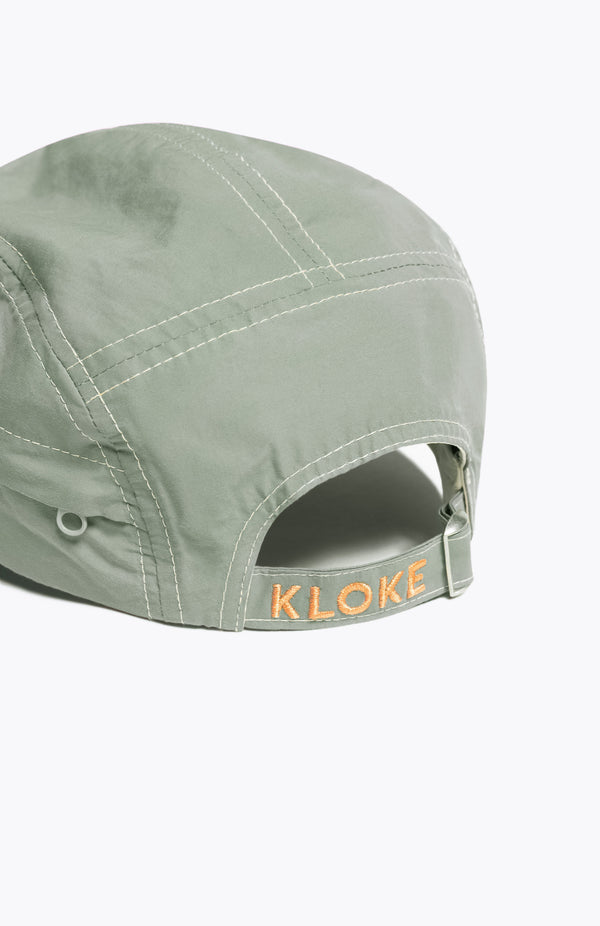 Back of the Unisex olive green 5-panel zip cap in quick-dry technical nylon with a hidden zip pocket, adjustable back strap, and subtle embroidered Kloke branding