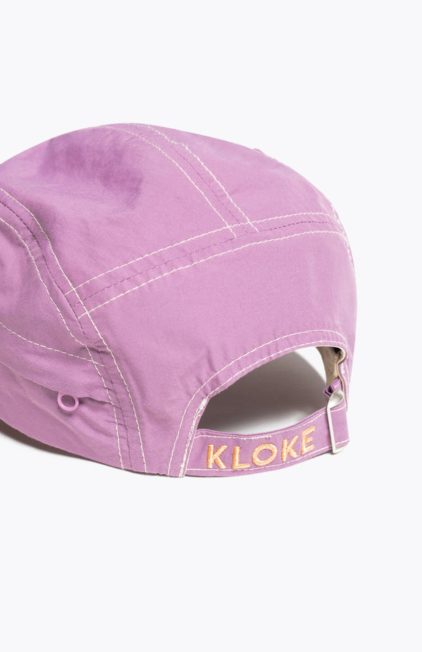 Back if the Unisex purple 5-panel zip cap in quick-dry technical nylon with a hidden zip pocket, adjustable back strap, and subtle embroidered Kloke branding