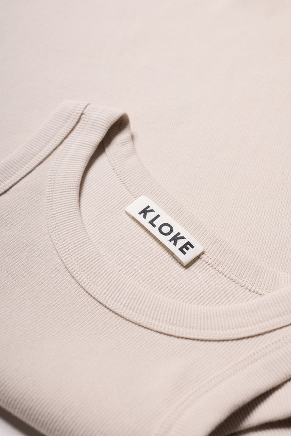 Close-up of ribbed Japanese cotton texture on Kloke racer-back tank in Bone (off white) 
